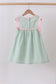Green swiss dot cross sheep ruffle dress