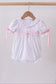 White cross smocked ruffle bubble