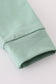 Sage pumpkin french knot ruffle top