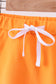 Orange scallop hem bow skort